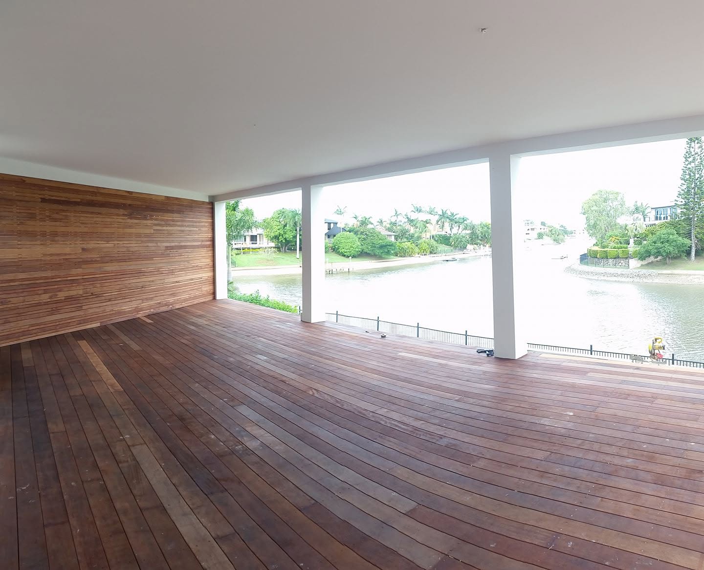 Finished hardwood deck under cover, looking out over a Gold Coast canal